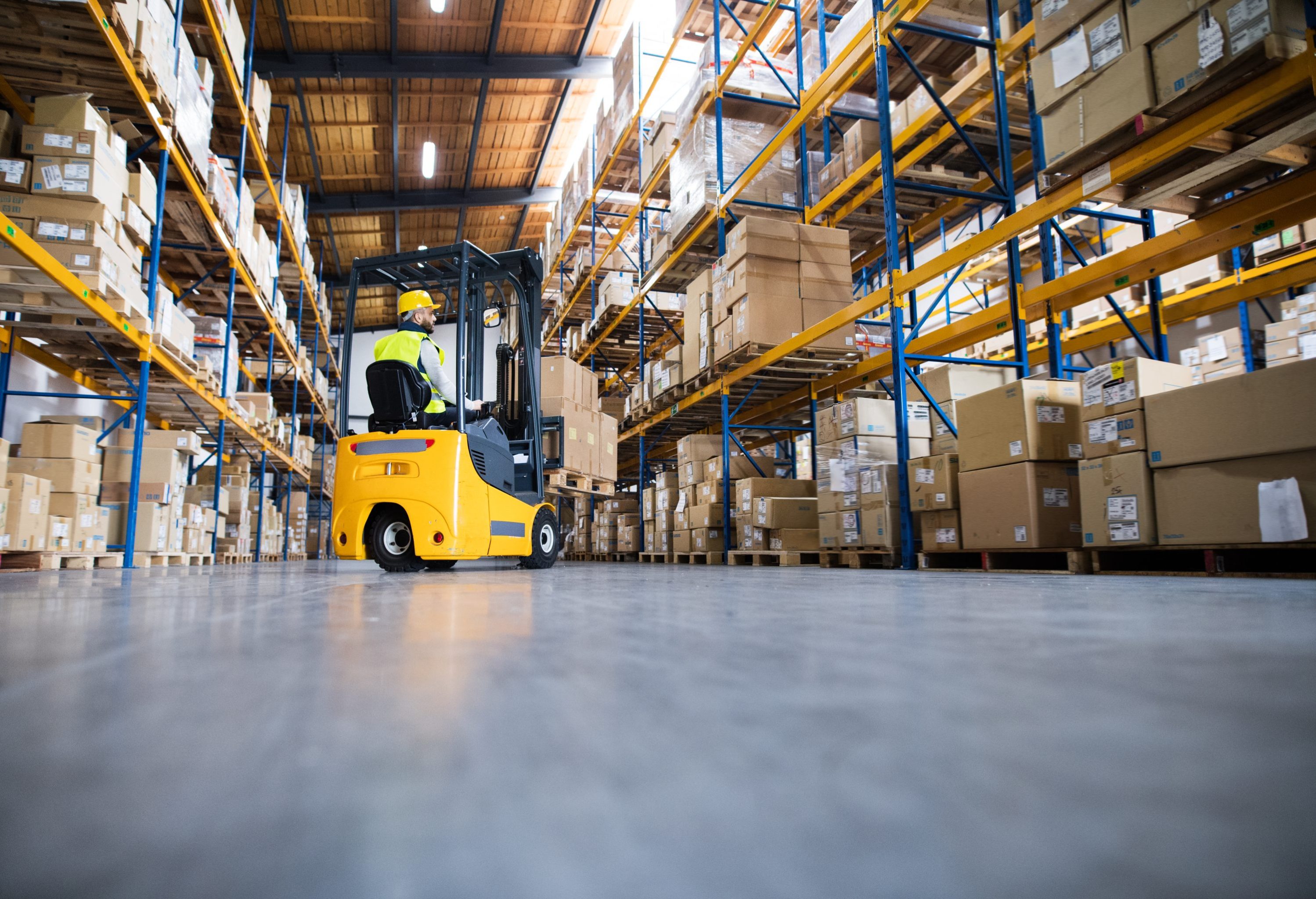 shutterstock_776936068 Forklift Driver Recruitment Agency worker. Highreach Forlift Driver in warehouse picking boxes.